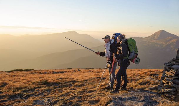 Couple hikers in the Carpathians mountains with backpacks - Photo, Image