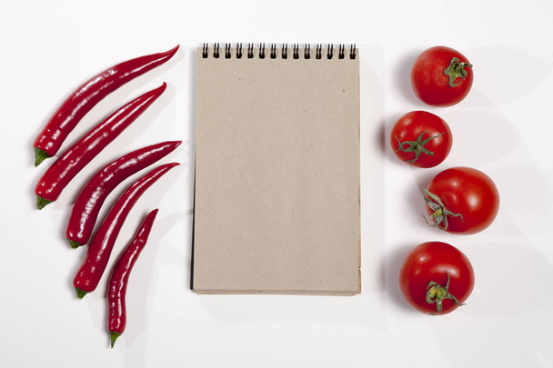 the Postcards for recipes. Sketchpad and red hot pepper as a frame on a white background. - Photo, Image