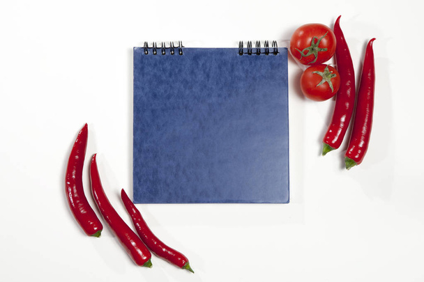 the Postcards for recipes/ Sketchpad and red hot pepper as a frame on a white background. - Fotografie, Obrázek