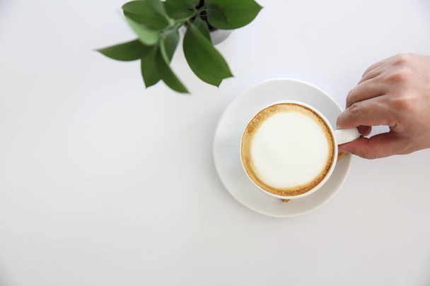 cappuccino coffee with hand on white background - Valokuva, kuva