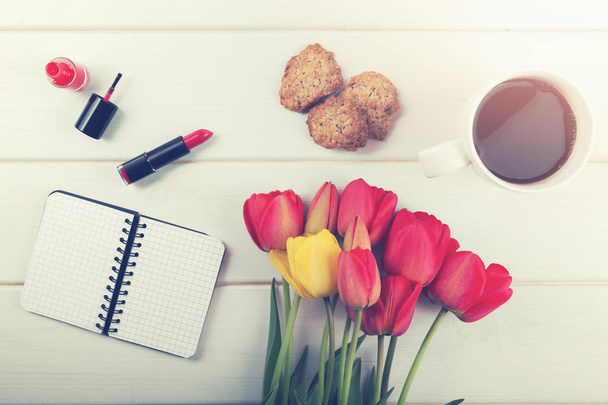 tulip flowers, coffee and other women's items on white wooden background - Photo, Image