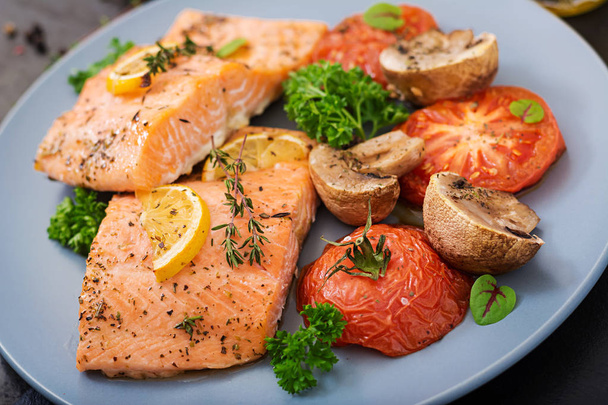 Baked salmon with tomatoes on plate - Photo, Image