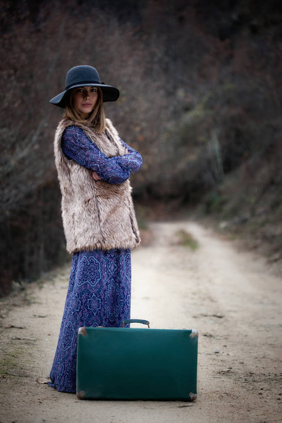 pretty girl with vintage case on a dirtroad - Photo, image