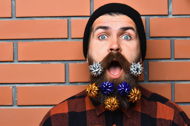 Bearded man, brutal caucasian surprised hipster with gift decoration stars - Fotó, kép