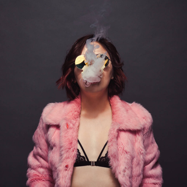 Trendy woman in smoke - Foto, Imagen