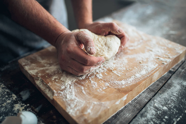 Baker kneading dough  - Fotó, kép