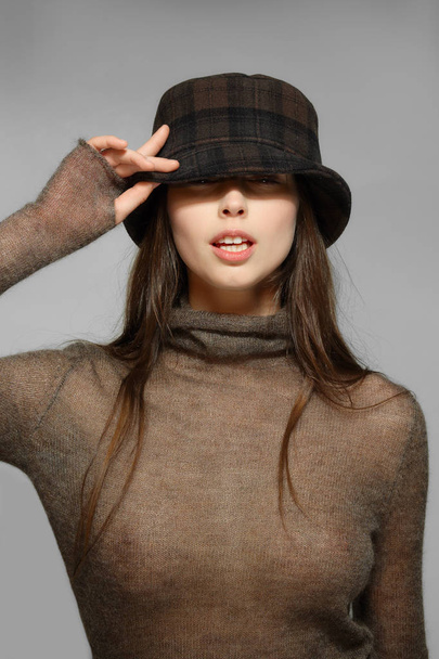 Beautiful fashion model in transparent angora sweater and plaid  - Zdjęcie, obraz