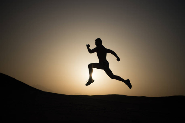 running man on mountain nature landscape on sky background - Zdjęcie, obraz