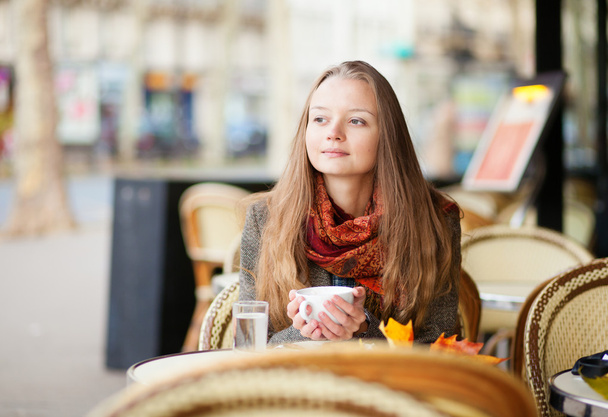 Pensive girl in a Parisian outdoor cafe - Foto, Imagem