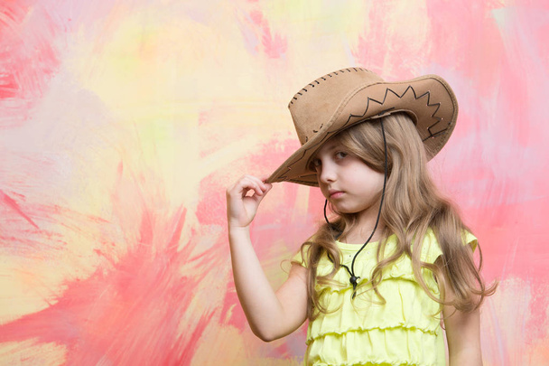 little girl in cowboy hat on colorful background, copy space - Fotoğraf, Görsel