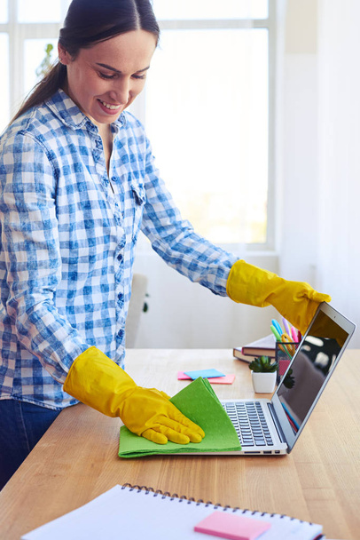Charming female with ponytail cleaning with mop laptop - Photo, Image