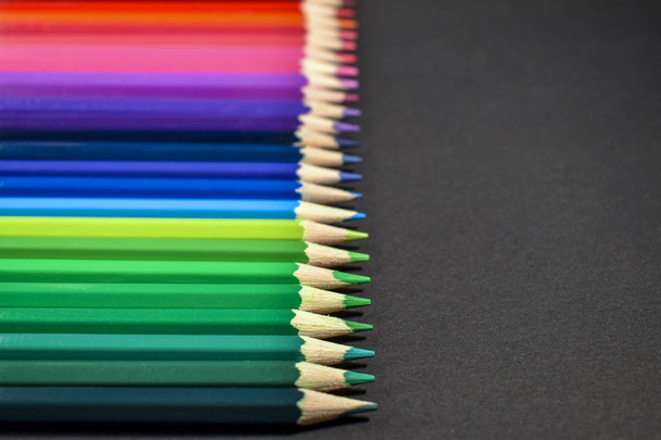 colored pencils on black background - Foto, imagen