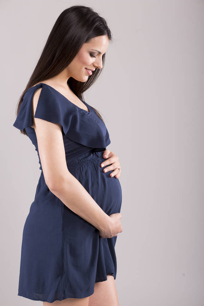 Isolated portrait of pregnant smiling woman in dress  - Fotografie, Obrázek