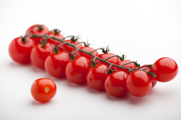 Bunch of ripe red cherry tomatoes close-up on white background - Photo, Image