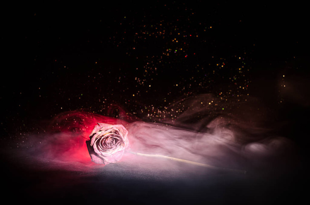 A wilting rose signifies lost love, divorce, or a bad relationship, dead rose on dark background - Photo, Image
