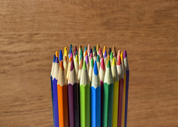 colored pencils on wood background - 写真・画像