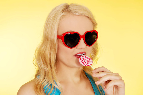 Young happy woman holding lollipop - Valokuva, kuva