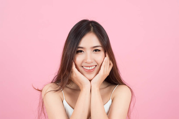 Asian young beautiful woman smiling and touch her face like a v- - Photo, Image