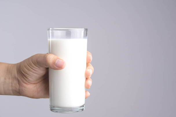 Bir bardak taze süt tutan el - Fotoğraf, Görsel
