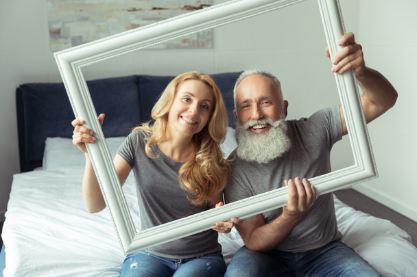 middle aged couple with white frame - Photo, Image