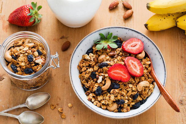 Granola with dried fruits nuts and strawberries in bowl  - Fotografie, Obrázek