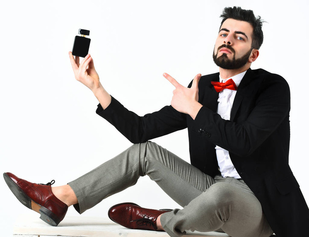 Bearded man, caucasian hipster with moustache and perfume bottle - Fotó, kép