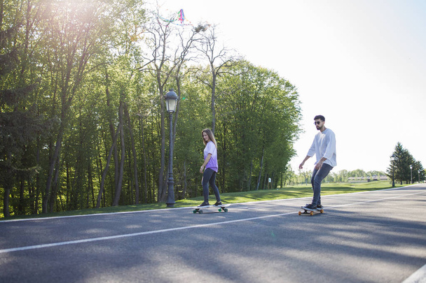 Young skateboarders on road  - Φωτογραφία, εικόνα