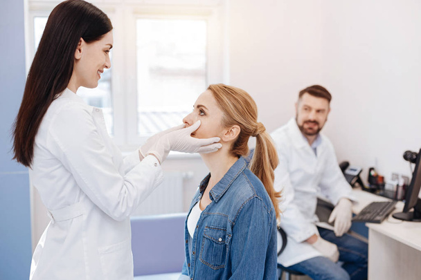 Cheerful delighted doctor looking into her patients face - Photo, Image
