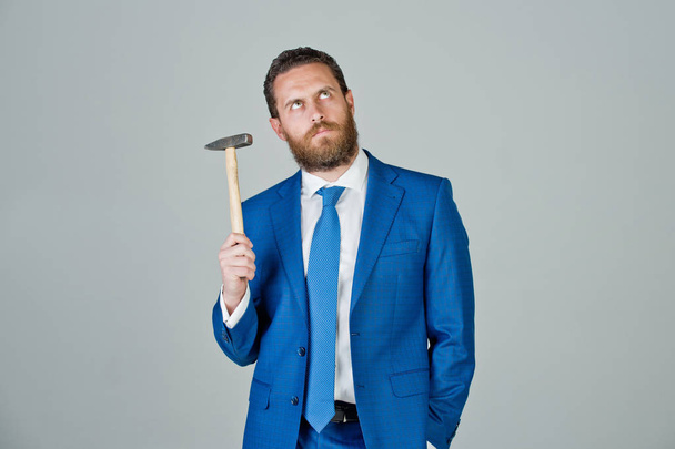 determined businessman with hammer in hands, business and success - 写真・画像