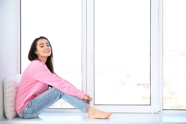 woman resting on windowsill - Фото, зображення