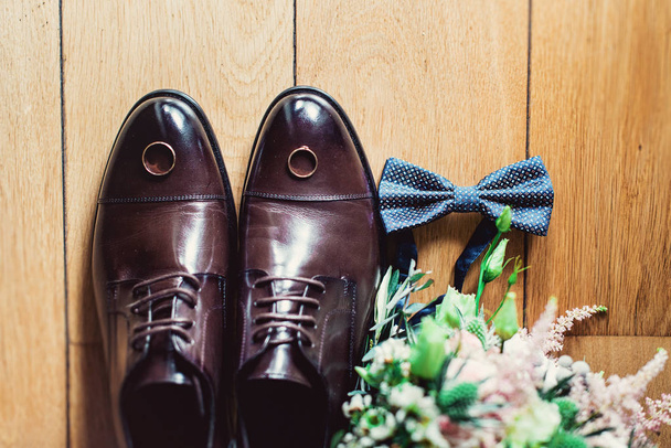 blue bow tie, leather shoes and wedding rings. Grooms wedding morning. Close up of modern man accessories - Zdjęcie, obraz