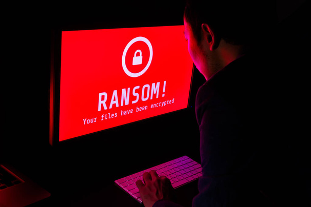 Computer screen with ransomware attack file encrypted alert in r - Photo, Image