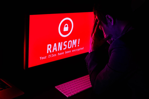 Computer screen with ransomware attack file encrypted alerts in  - Photo, Image