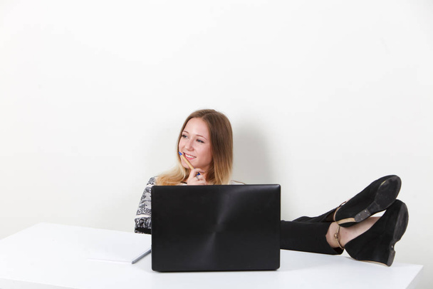 Businesswoman sitting at office feet on table - Фото, зображення