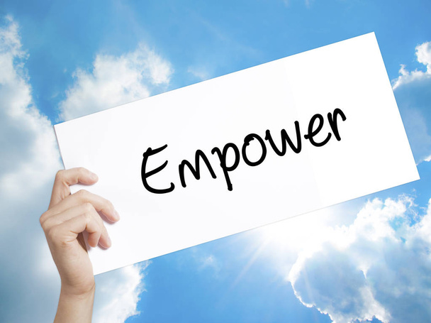 Empower Sign on white paper. Man Hand Holding Paper with text. I - Photo, Image