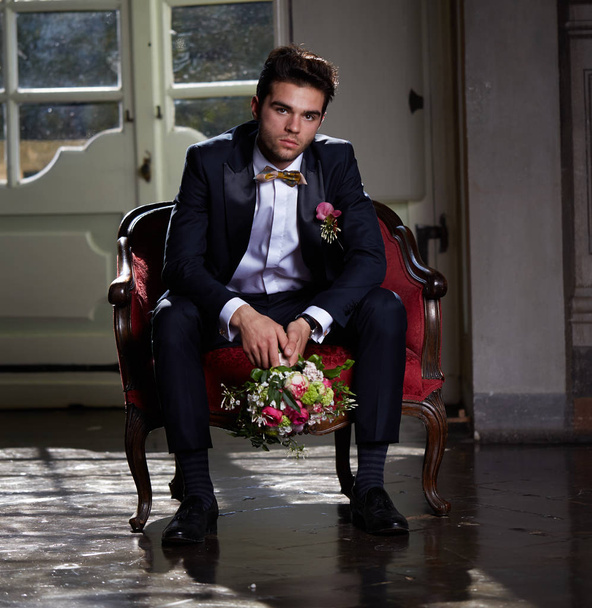 young groom waiting his bride on sofa - Photo, image