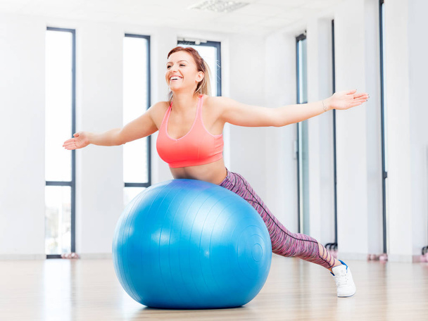 woman training with fitball at fitness club - Fotó, kép