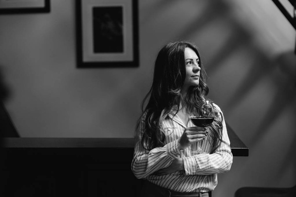 young woman  with a glass of wine - 写真・画像