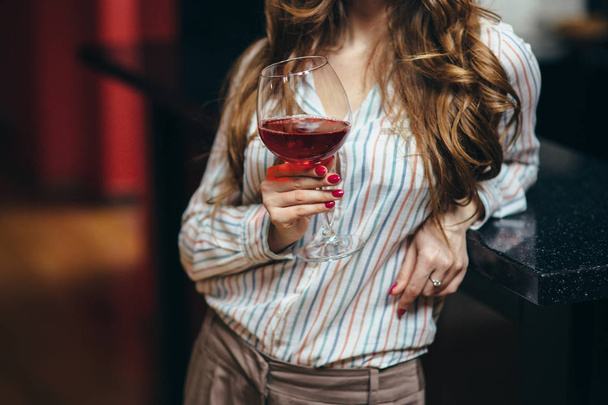 young woman  with a glass of wine - Zdjęcie, obraz
