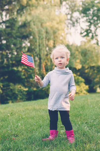 girl holding and waving American flag  - Photo, Image