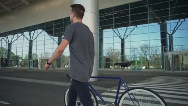 Man holding his bike and walking slow motion - Video