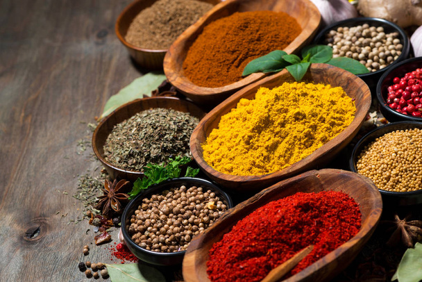 assortment of oriental spices on a wooden background, top view - Foto, Bild