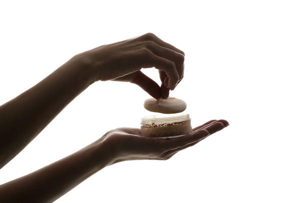 silhouette of female hands holding face powder isolated on white background - Photo, Image