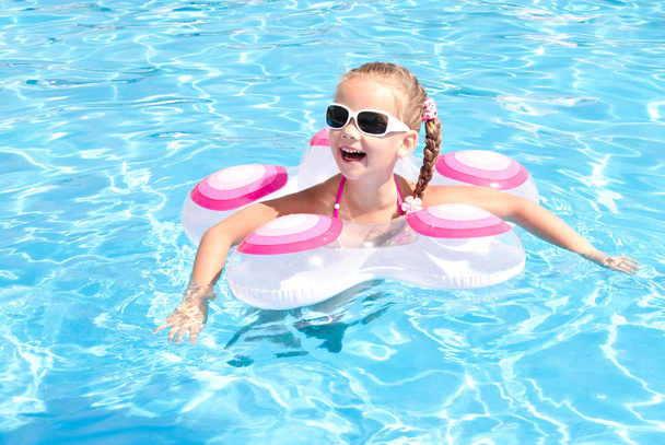Улыбающаяся маленькая девочка в бассейне
  - Фото, изображение
