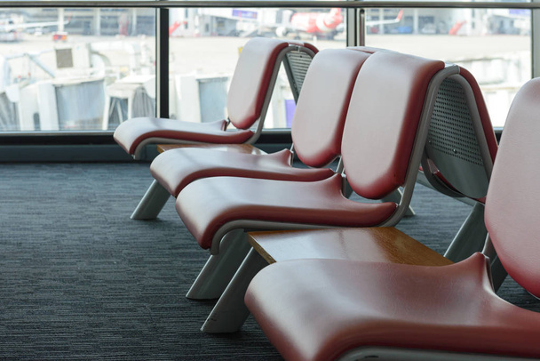Departure lounge with empty chairs in the terminal of airport, waiting area - Photo, Image