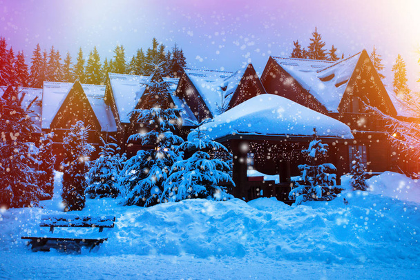 A fairy-tale house in the woods amid the snow-covered fir trees - Fotó, kép