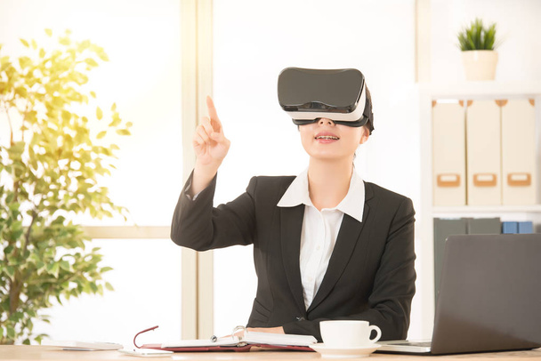 excited young woman using a VR headset - Foto, Imagen