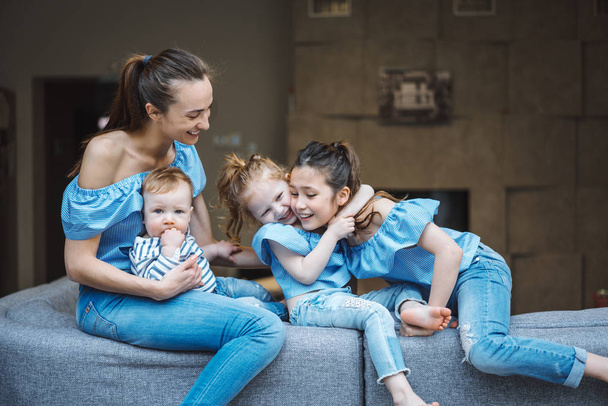 Maman, deux filles et un petit fils sur le canapé - Photo, image