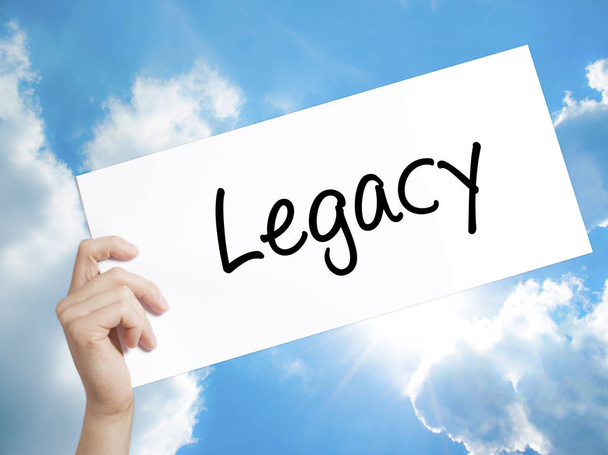 Legacy Sign on white paper. Man Hand Holding Paper with text. Is - Photo, Image