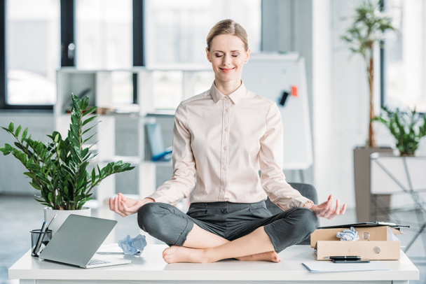 businesswoman meditating in lotus position - Photo, Image